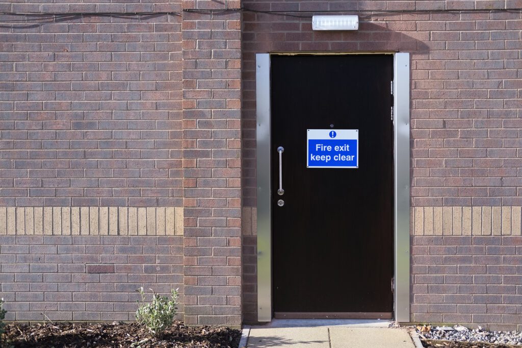 Fire exit keep clear on black door at hotel, external fire doors