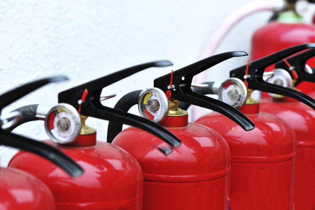 six fire extinguishers lined up